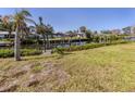 Waterfront view of a private dock and boat lift, surrounded by lush greenery and clear blue skies at 506 Buena Vista Dr, Nokomis, FL 34275