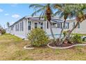 Attractive single-story home featuring well-manicured landscaping with mature trees and vibrant green grass at 508 Blackburn Blvd, North Port, FL 34287