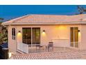 Outdoor balcony featuring a built-in bar, plenty of seating and relaxing space, and sliding glass doors at 632 Valencia Rd, Venice, FL 34285