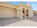 Elegant building exterior showcasing a two-car garage, tiled roof, and a covered entryway with stately columns at 718 Golden Beach Blvd # 2, Venice, FL 34285