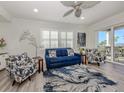 Bright living room with comfortable seating, stylish decor, and access to a balcony with views at 830 The Esplanade N # 201, Venice, FL 34285