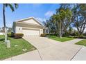 Single Gathering home featuring an attached two-car garage and mature landscaping at 8603 46Th Avenue W Cir, Bradenton, FL 34210