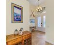Bright foyer featuring tiled floor, high ceilings, and decorative furnishings at 9407 Prospect Ave, Englewood, FL 34224