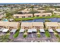 An aerial view of the condo community showcasing waterfront property and pool access at 410 Mission E Trl # H, Venice, FL 34285