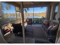 Relaxing screened lanai with comfortable seating and serene lake views at 102 Mestre Ct, North Venice, FL 34275