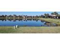 Scenic view of the pond, with houses reflected in the calm water at 102 Mestre Ct, North Venice, FL 34275