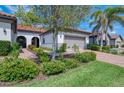 Well-manicured front yard and brick driveway enhance the exterior of this charming home at 11810 Tapestry Ln, Venice, FL 34293