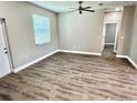 Bright bedroom with modern flooring, a ceiling fan, and a doorway to another room at 12316 Durango Ave, North Port, FL 34287