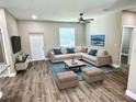 Inviting living room with stylish decor, comfortable seating, and a ceiling fan for added comfort at 12316 Durango Ave, North Port, FL 34287