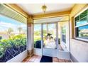 Enclosed porch featuring an decorative security door and tile floor at 1330 Berkshire Ct, Venice, FL 34292