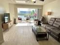Comfortable living room with water view, patio access, and lots of light at 1401 S Mccall Rd # 106, Englewood, FL 34223