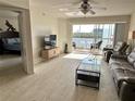 Inviting living room with patio doors and view of the lake at 1401 S Mccall Rd # 106, Englewood, FL 34223