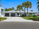 Charming single-story home with a well-manicured lawn, ample parking, and a welcoming entrance at 1604 Casey Key Rd, Nokomis, FL 34275