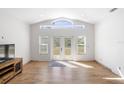 Bright, airy living room featuring a large window, neutral walls, and a sleek entertainment center at 1871 Bridge St, Englewood, FL 34223