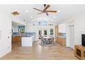 Spacious room showcases an open-concept layout with a modern kitchen and a dining area, brightened by natural light at 1871 Bridge St, Englewood, FL 34223