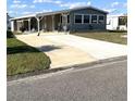 Inviting home with covered parking and a well-maintained front lawn at 199 Palm Harbor Dr, North Port, FL 34287