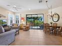 Bright and open living room with large sliding doors leading to the lanai and outdoor space at 20390 Cavallo Ct, Venice, FL 34292