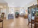 Inviting living room with neutral tones, tile flooring, and access to the lanai, offering a relaxing atmosphere at 20390 Cavallo Ct, Venice, FL 34292