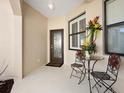 Cozy entryway with decorative glass door, adorned with an elegant floral arrangement and wrought iron furniture at 2059 Batello Dr, Venice, FL 34292