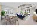 A bright living and dining area with recessed lights, tile floors, and slider doors at 27440 Janzen Ct, Englewood, FL 34223