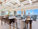 Spacious living area with coffered ceilings, expansive windows overlooking the ocean, and elegant coastal-inspired decor at 2821 Casey Key Rd, Nokomis, FL 34275