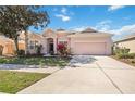 Charming single-story home with a well-manicured lawn and a spacious two-car garage on a sunny day at 312 Londonderry Dr, Sarasota, FL 34240
