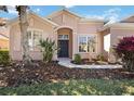Charming home featuring a manicured lawn and neatly landscaped flowerbeds leading to a welcoming front entrance at 312 Londonderry Dr, Sarasota, FL 34240