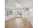 Bright living room featuring wood floors, a large window, and modern lighting fixtures for a stylish and inviting space at 312 Londonderry Dr, Sarasota, FL 34240