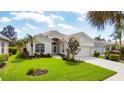 Charming single-story home featuring a pristine lawn, well-maintained landscaping, and an attached garage at 339 Marsh Creek Rd, Venice, FL 34292