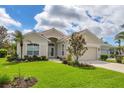 Beautiful single-story home with lush landscaping, a tile roof, and a well-manicured lawn at 339 Marsh Creek Rd, Venice, FL 34292