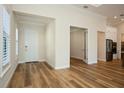 Bright foyer with hardwood floors, a white front door, and views into adjacent rooms at 448 Bocelli Dr, Nokomis, FL 34275