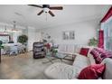 Bright living room featuring neutral walls, tile floors, modern ceiling fan, and comfortable furniture at 4802 51St W St # 1816, Bradenton, FL 34210