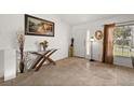 Bright entryway featuring tile flooring, decorative accents, and a charming foyer table at 5458 Jessamine Ave, North Port, FL 34291
