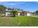Inviting single-story home with a well-manicured front lawn and attached two-car garage at 5458 Jessamine Ave, North Port, FL 34291