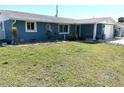 Charming single-story home featuring a well-manicured lawn and blue exterior at 599 Carmel Rd, Venice, FL 34293