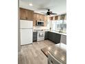 Galley kitchen featuring classic cabinets, laminate countertops and views to the lanai area at 601 Apalachicola Rd, Venice, FL 34285