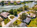 Waterfront home features a circle driveway and lush green lawn at 6146 Rockefeller Ave, Sarasota, FL 34231