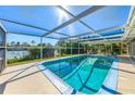 Relaxing screened-in pool features beautiful waterfront views at 6146 Rockefeller Ave, Sarasota, FL 34231