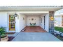 Open-air carport featuring a decorative sunburst design, seating, and tiled flooring at 72 Circlewood Dr # A2-7, Venice, FL 34293