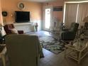 Cozy living room featuring tile floors, wainscotting, and comfortable seating around a floral rug at 72 Circlewood Dr # A2-7, Venice, FL 34293