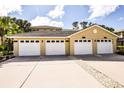 Four garages with white doors and concrete driveway offer convenient parking and storage at 780 Montrose Dr # 201, Venice, FL 34293