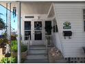 Inviting entrance with decorative plants, a welcome sign, and charming details create a warm first impression at 822 Bogie St, Venice, FL 34285