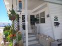 Inviting entrance with decorative plants, a welcome sign, and charming details create a warm first impression at 822 Bogie St, Venice, FL 34285