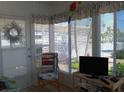 Cozy sun room with bright windows, a comfortable chair, and stylish decor at 822 Bogie St, Venice, FL 34285