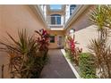 Inviting entryway with lush plants and a charming walkway leading to the front door at 903 Gondola Park Dr # 903, Venice, FL 34292