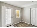 Bright entry room featuring wood-look floors, closet, and backyard access at 903 Gondola Park Dr # 903, Venice, FL 34292