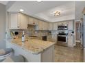 Well-equipped kitchen with granite countertops, stainless steel appliances, and ample cabinet space for storage at 1 Colony Point Dr # 11A, Punta Gorda, FL 33950