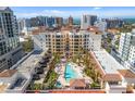 A captivating aerial view of the building featuring a pool, palm trees, and well-maintained landscaping at 100 Central Ave # C619, Sarasota, FL 34236