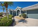 Charming home exterior featuring a two-car garage and neatly landscaped front yard at 1125 Deardon Dr, Venice, FL 34292