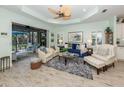Bright living room with neutral paint, wood floors, and sliding glass doors to the lanai at 11575 Okaloosa Dr, Venice, FL 34293